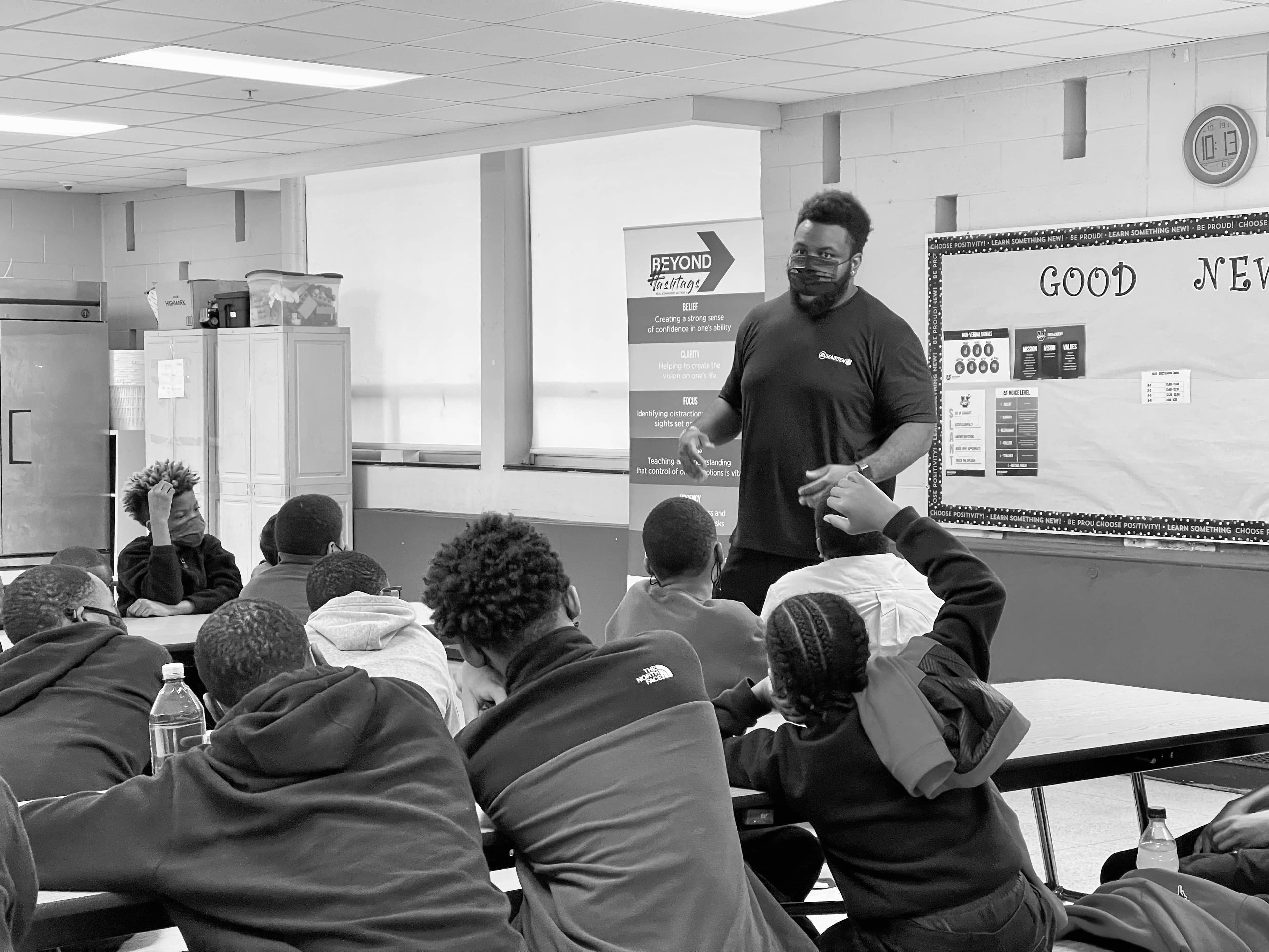 Caj Reynolds speaking with students in a classroom